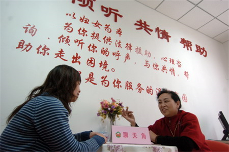 天津市丹江里社区的热线咨询员王硕舫（右）在与来访妇女交流.jpg